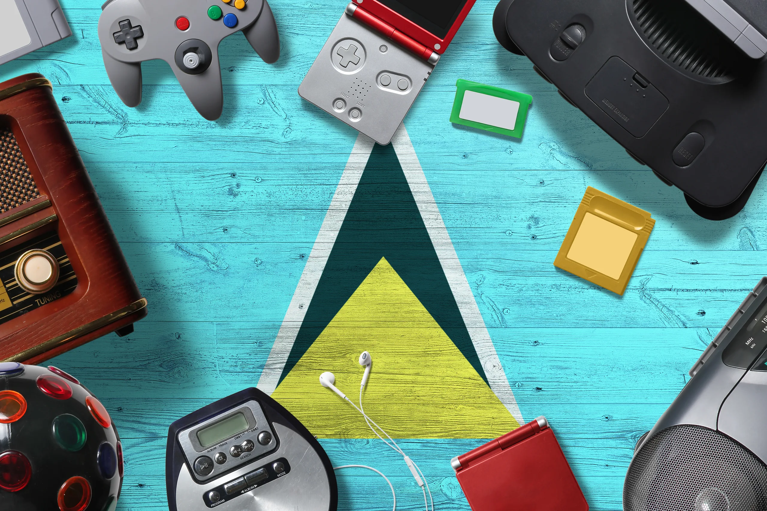 Saint Lucia retro gaming concept. A collection of retro video game controllers shot from above on a national background.